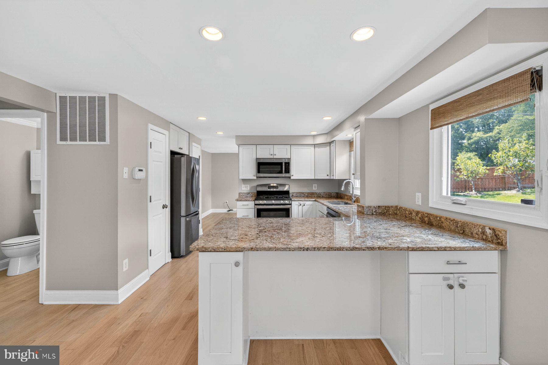 7518 Candytuft Court Springfield, VA 22153 - Photo 10 of 47 a kitchen with stainless steel appliances granite countertop a refrigerator and a stove top oven