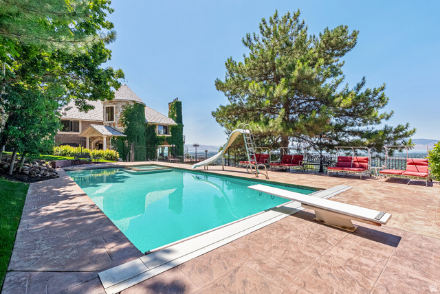 4093 North Imperial Way Provo, UT 84604 - Photo 80 of 96 Rectangular swimming pool with an integrated spa, diving board, and slide