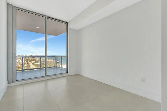 an empty room with windows and view of lake view