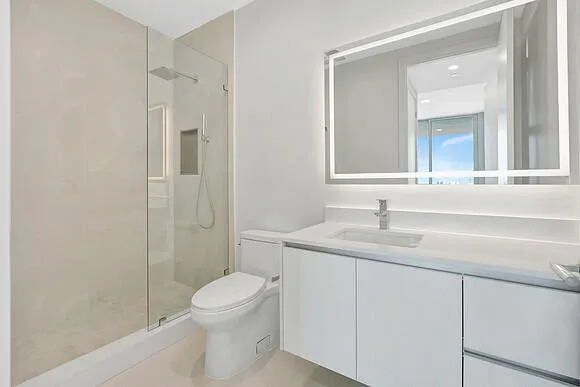 a bathroom with a toilet a sink and mirror