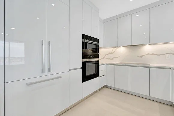 a kitchen with cabinets and stainless steel appliances