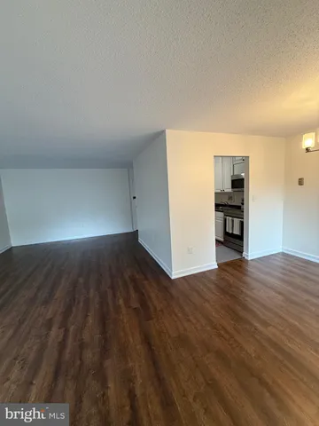 a view of a room with wooden floor
