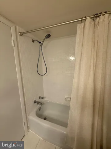 a bathroom with a shower and a sink