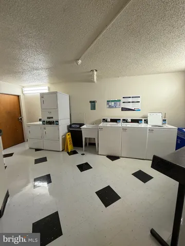 a room with furniture a flat screen tv and a lamp