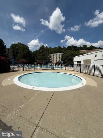 a view of a swimming pool with a yard