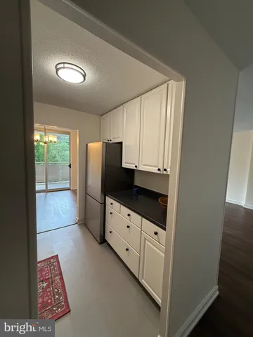 a kitchen with stainless steel appliances a refrigerator sink and cabinets