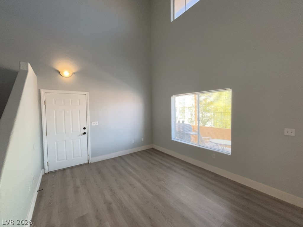 A living area with lofty ceilings and rich flooring.