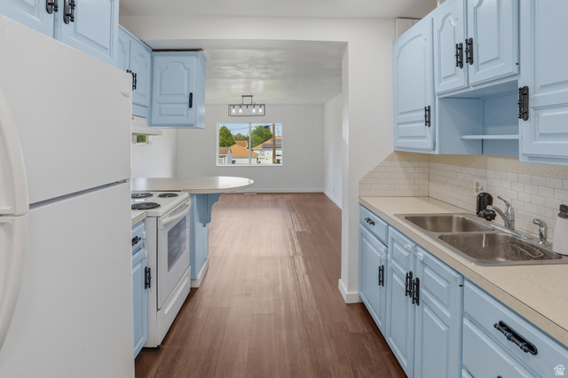 774 37th Street South Ogden, UT 84403 - Photo 6 of 47 Kitchen featuring light blue cabinetry with dark hardware, white subway tile backsplash, and a double basin stainless steel sink