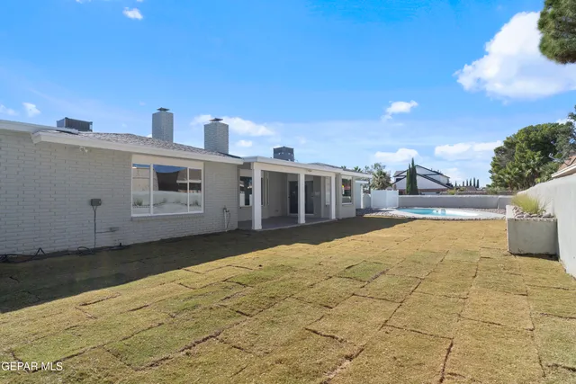 a swimming pool with buildings in the background