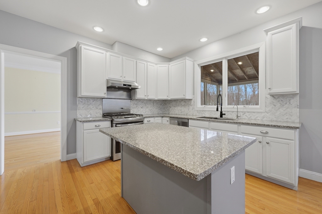 35 Peter Street Holliston, MA 01746 - Photo 12 of 42 a kitchen with stainless steel appliances granite countertop a sink stove and refrigerator