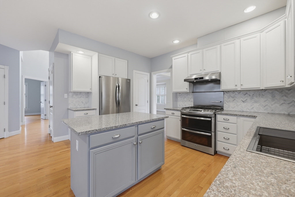 35 Peter Street Holliston, MA 01746 - Photo 13 of 42 a kitchen with stainless steel appliances granite countertop a stove a sink and a refrigerator