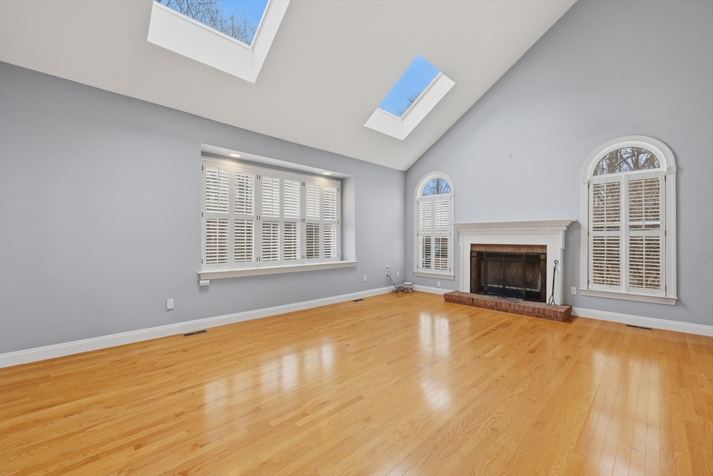 35 Peter Street Holliston, MA 01746 - Photo 15 of 42 a view of an empty room with a fireplace and a window