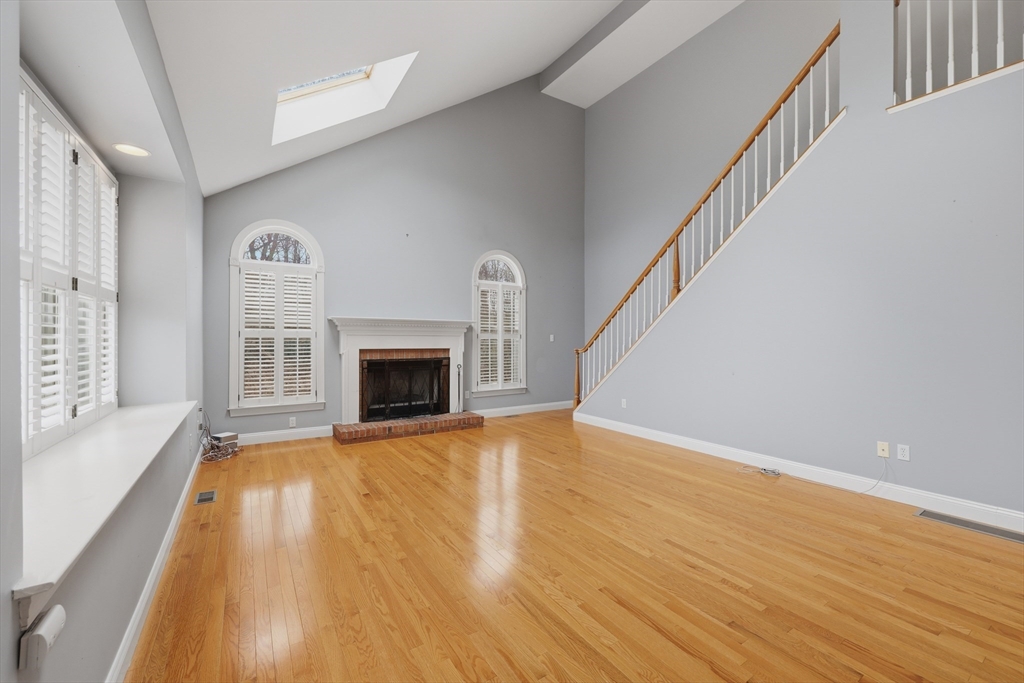 35 Peter Street Holliston, MA 01746 - Photo 16 of 42 a view of empty room with wooden floor and fireplace