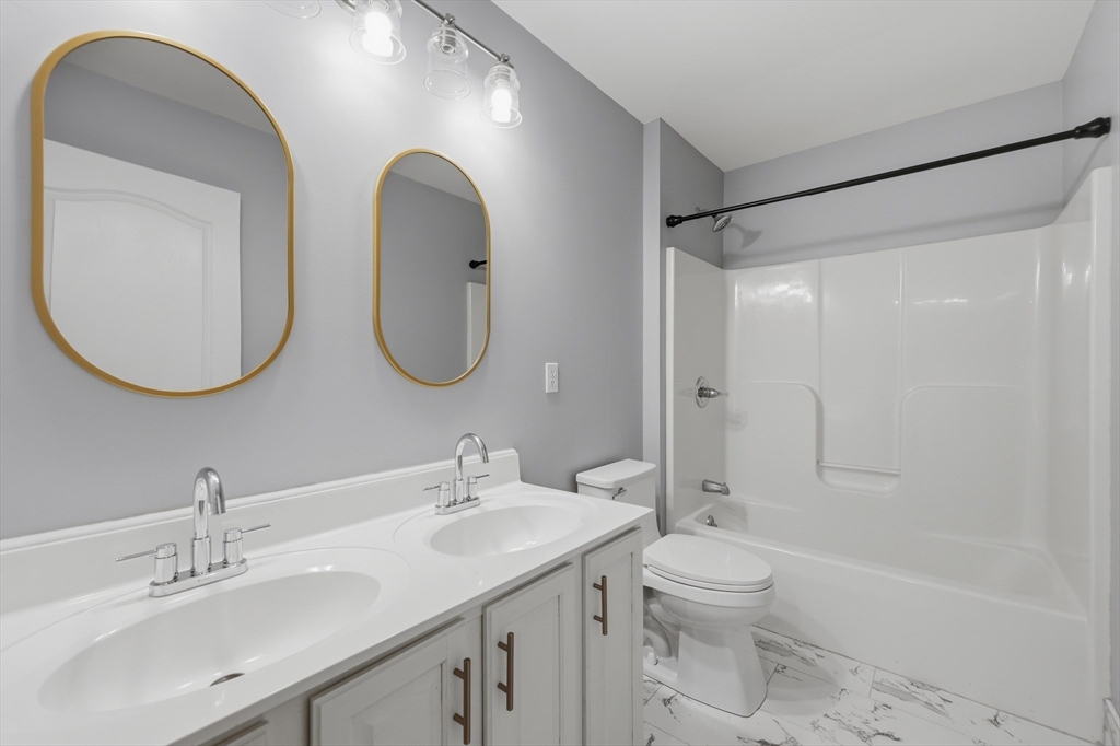 35 Peter Street Holliston, MA 01746 - Photo 31 of 42 a bathroom with a toilet a sink and a mirror