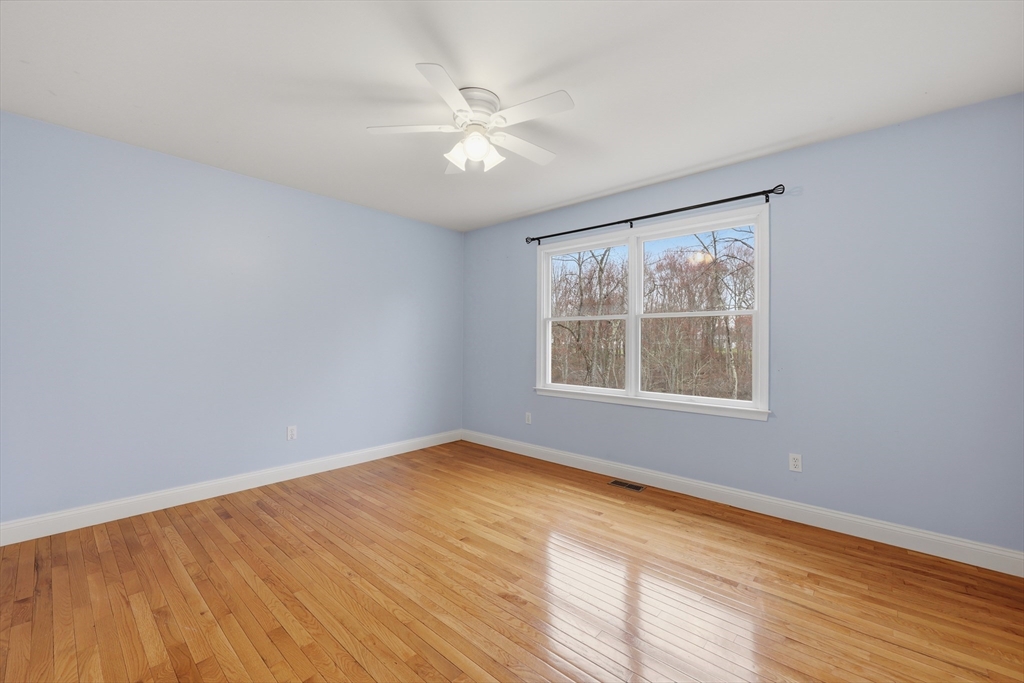 35 Peter Street Holliston, MA 01746 - Photo 32 of 42 a view of an empty room with wooden floor and a window
