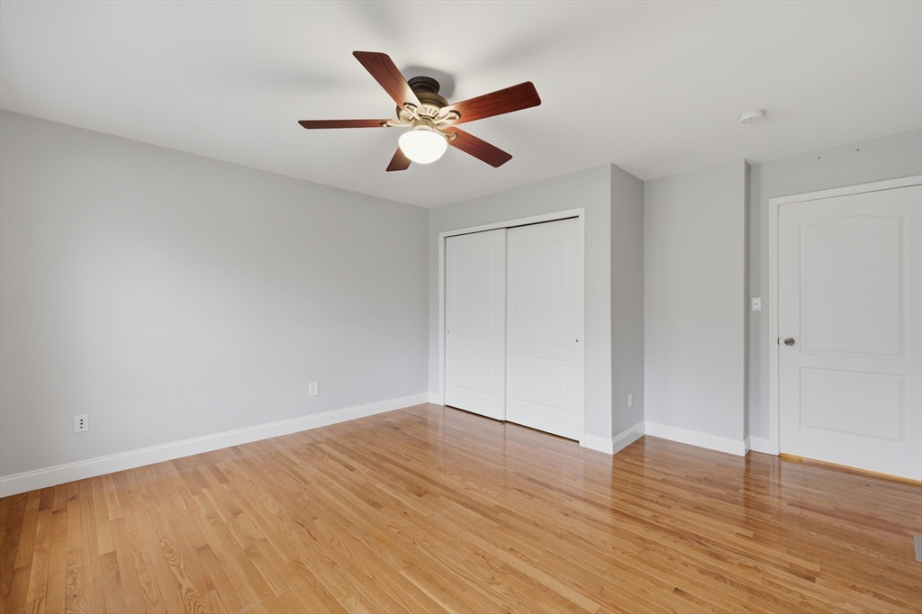 35 Peter Street Holliston, MA 01746 - Photo 35 of 42 a view of an empty room with wooden floor