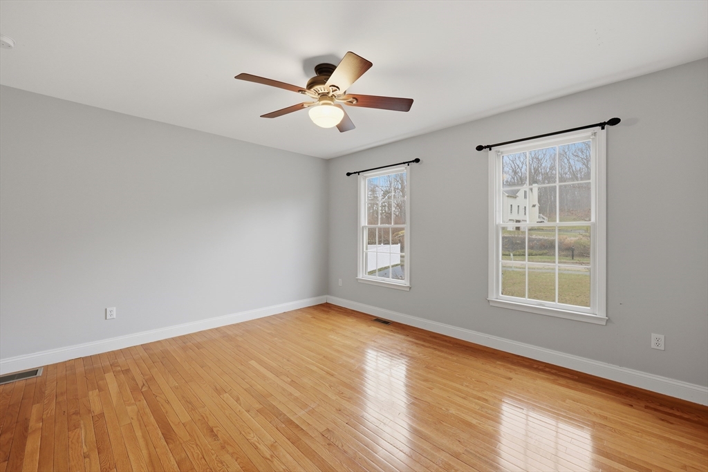 35 Peter Street Holliston, MA 01746 - Photo 36 of 42 a view of empty room with wooden floor and fan