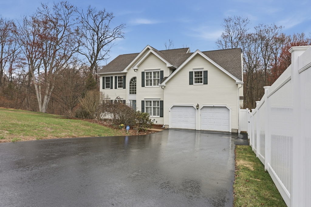 35 Peter Street Holliston, MA 01746 - Photo 39 of 42 a view of a white house next to a yard with big trees
