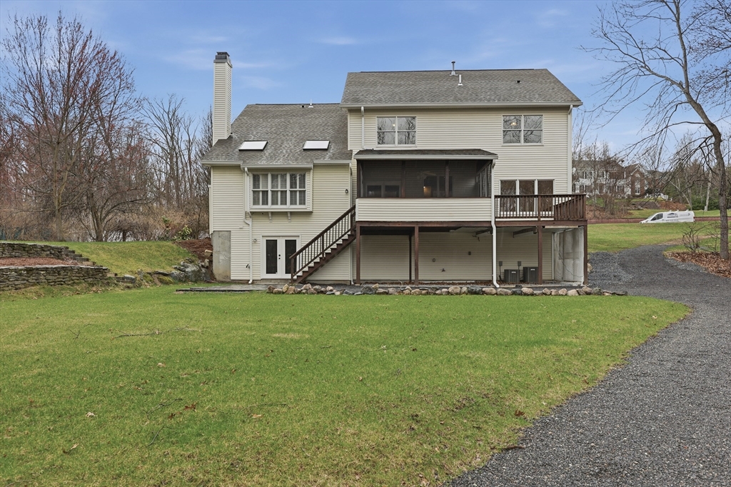 35 Peter Street Holliston, MA 01746 - Photo 41 of 42 a view of a big house with a big yard and large trees