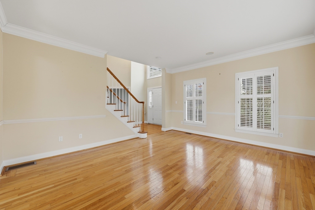 35 Peter Street Holliston, MA 01746 - Photo 6 of 42 a view of an empty room with wooden floor and a window