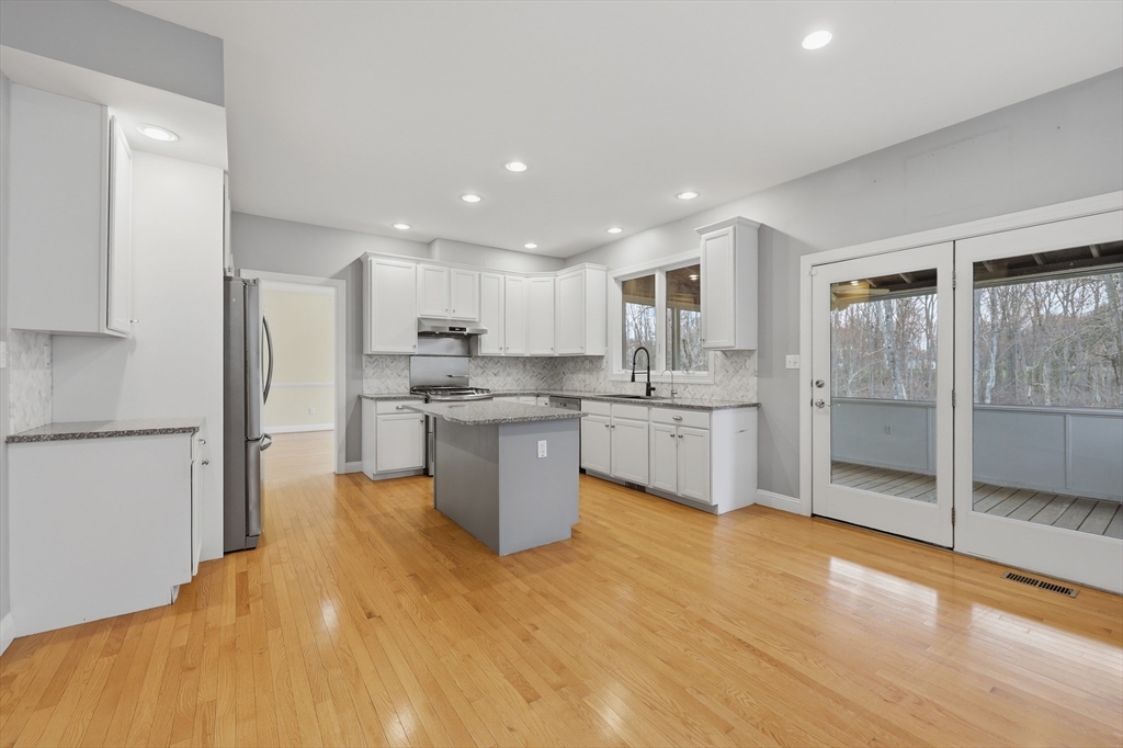 35 Peter Street Holliston, MA 01746 - Photo 10 of 42 a kitchen with stainless steel appliances granite countertop a refrigerator a sink a stove and a refrigerator