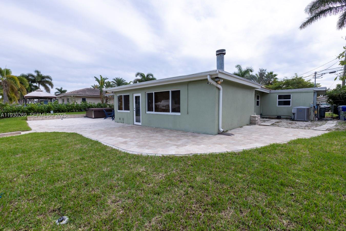 2875 Northeast 19th Street Pompano Beach, FL 33062 - Photo 35 of 79 a view of a house with a yard and sitting area