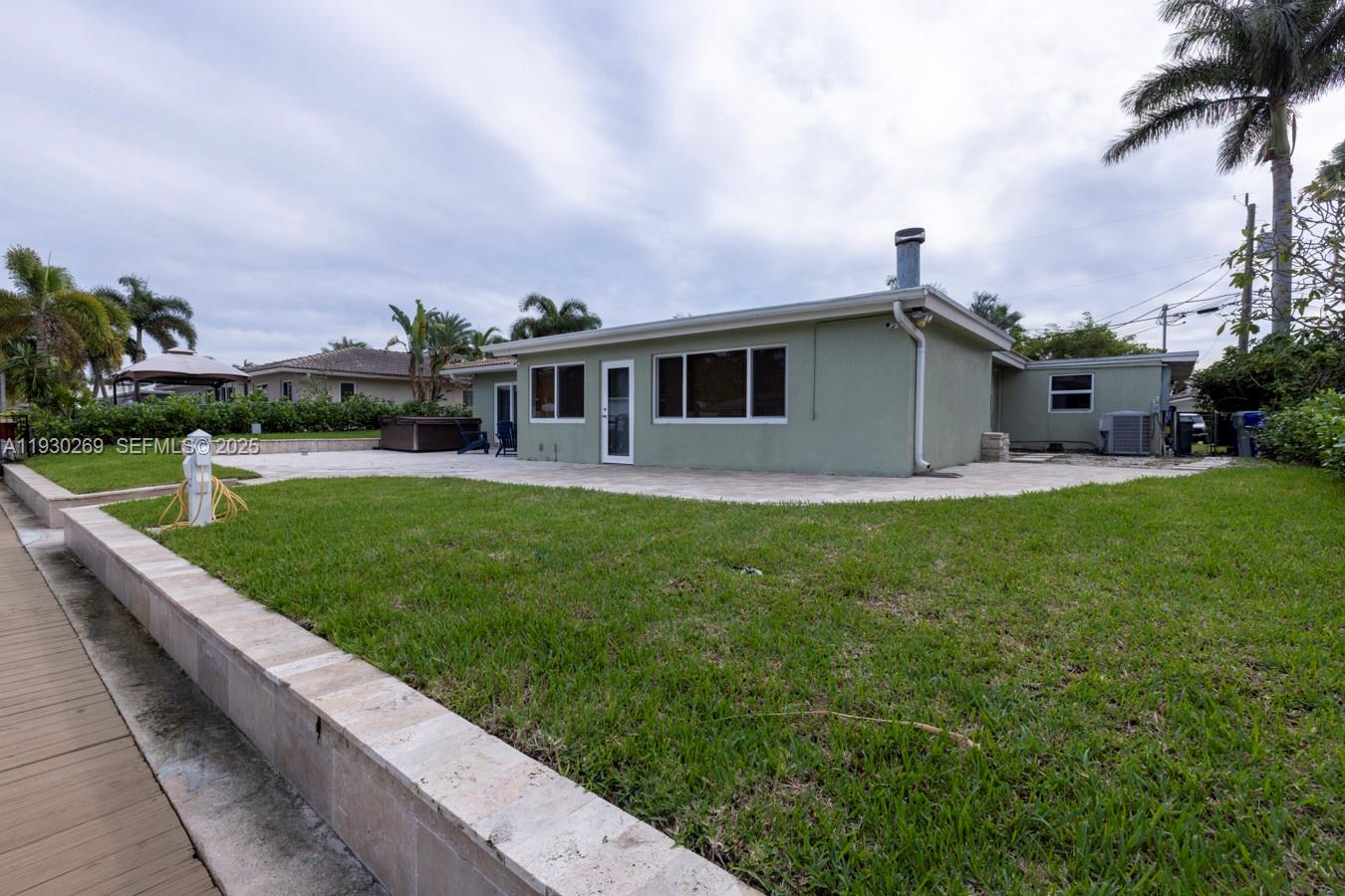 2875 Northeast 19th Street Pompano Beach, FL 33062 - Photo 37 of 79 a front view of house with yard and green space