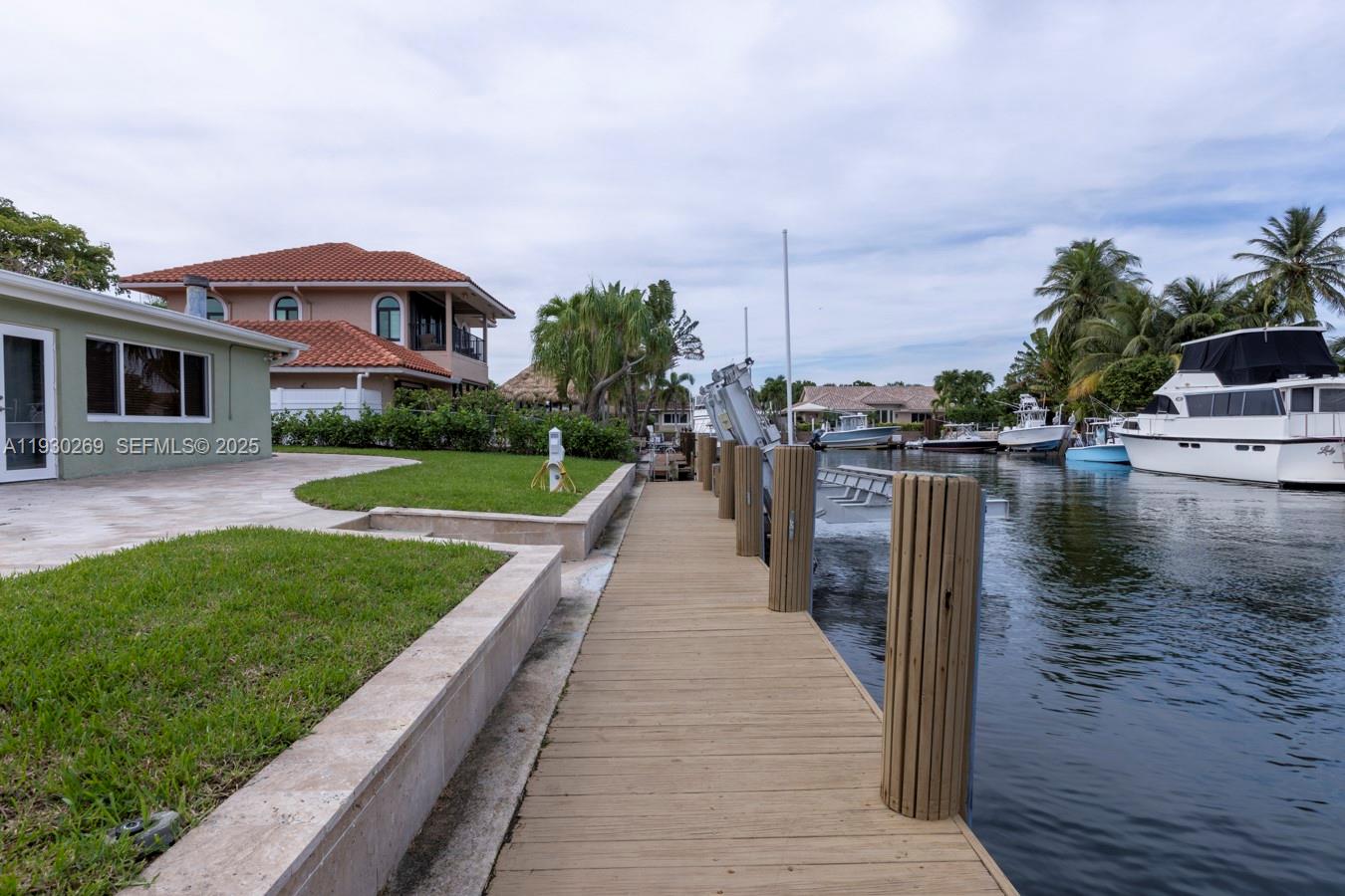 2875 Northeast 19th Street Pompano Beach, FL 33062 - Photo 40 of 79 a front view of a house with a yard and lake view