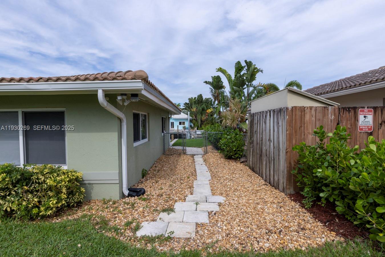 2875 Northeast 19th Street Pompano Beach, FL 33062 - Photo 48 of 79 a front view of a house with a garden