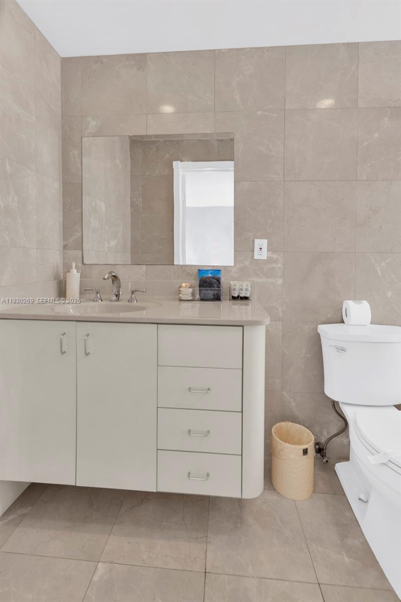 2875 Northeast 19th Street Pompano Beach, FL 33062 - Photo 52 of 79 a bathroom with a sink and a toilet