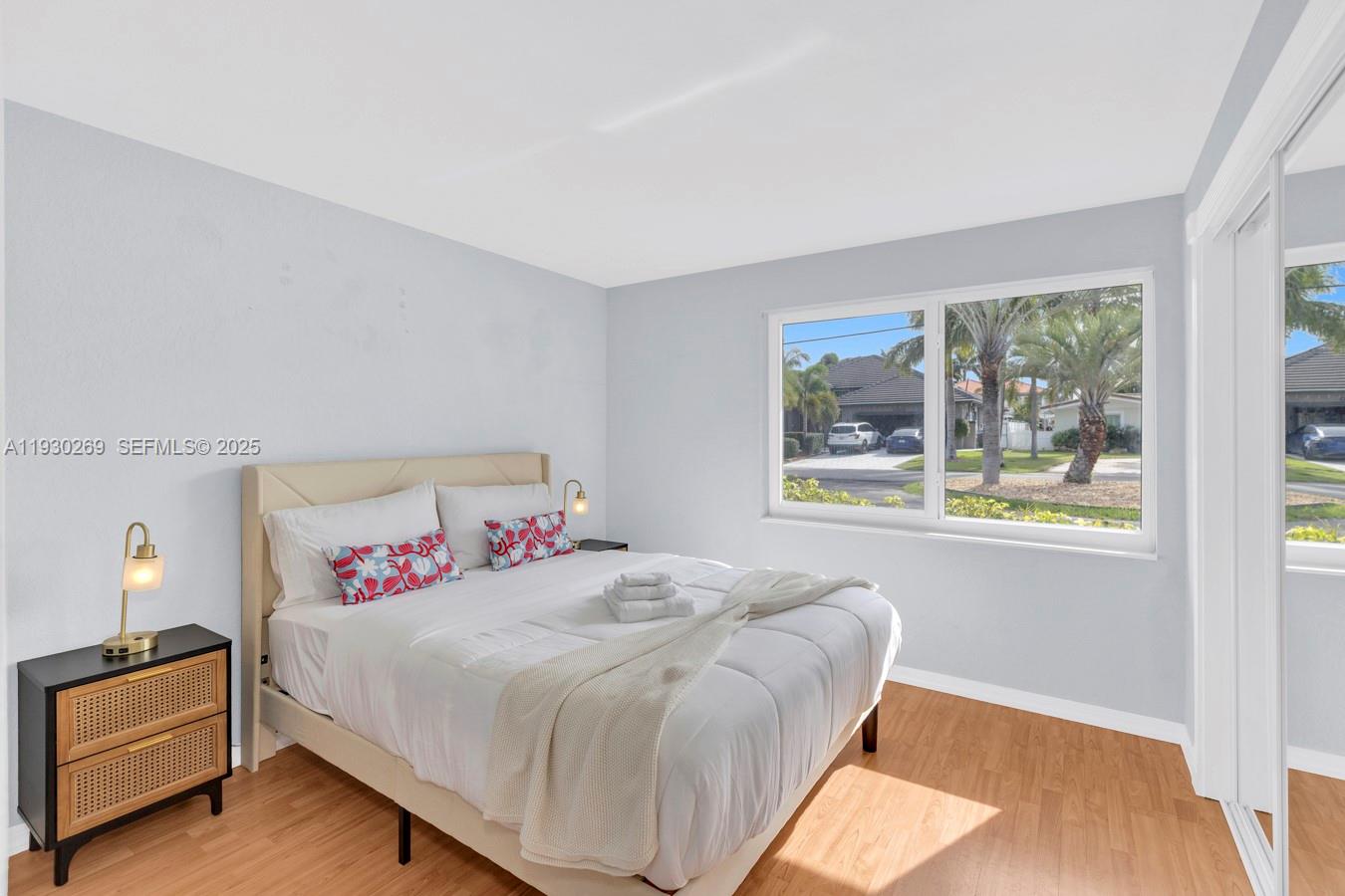 2875 Northeast 19th Street Pompano Beach, FL 33062 - Photo 55 of 79 a bedroom with a bed and a large window