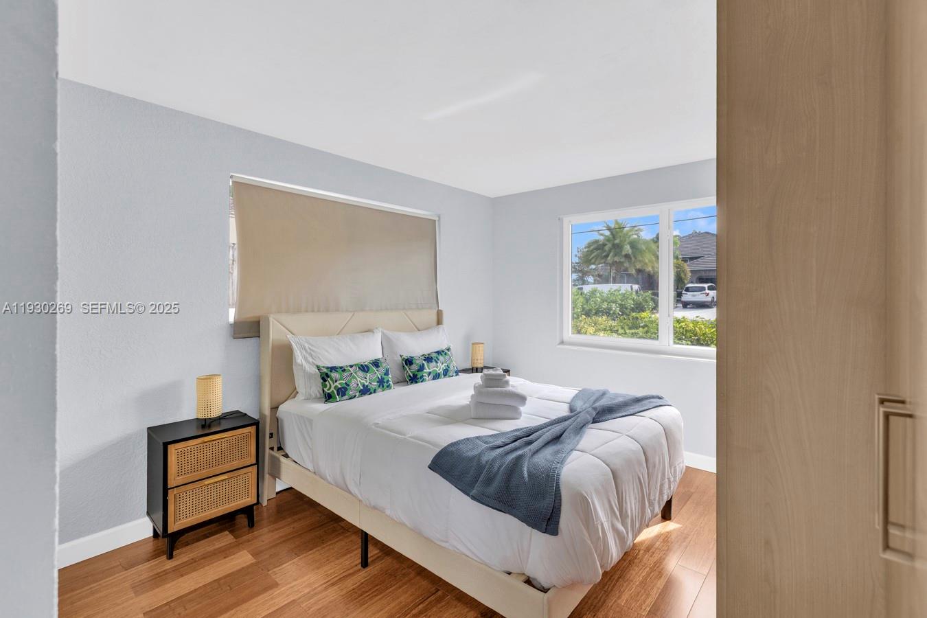 2875 Northeast 19th Street Pompano Beach, FL 33062 - Photo 60 of 79 a bedroom with a bed and a window