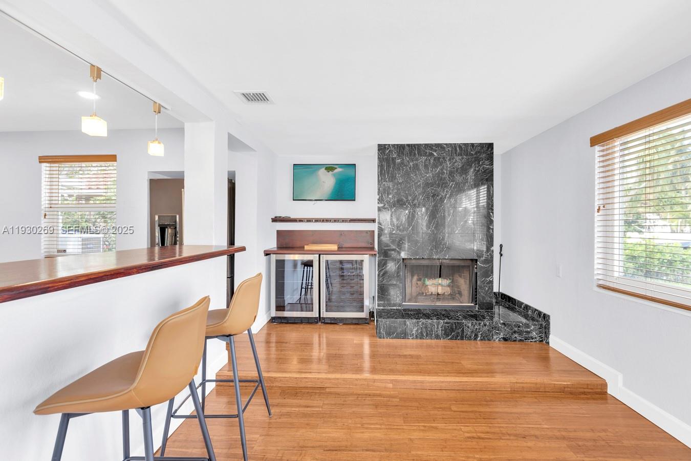 2875 Northeast 19th Street Pompano Beach, FL 33062 - Photo 64 of 79 a dining room with wooden floor and a floor to ceiling window