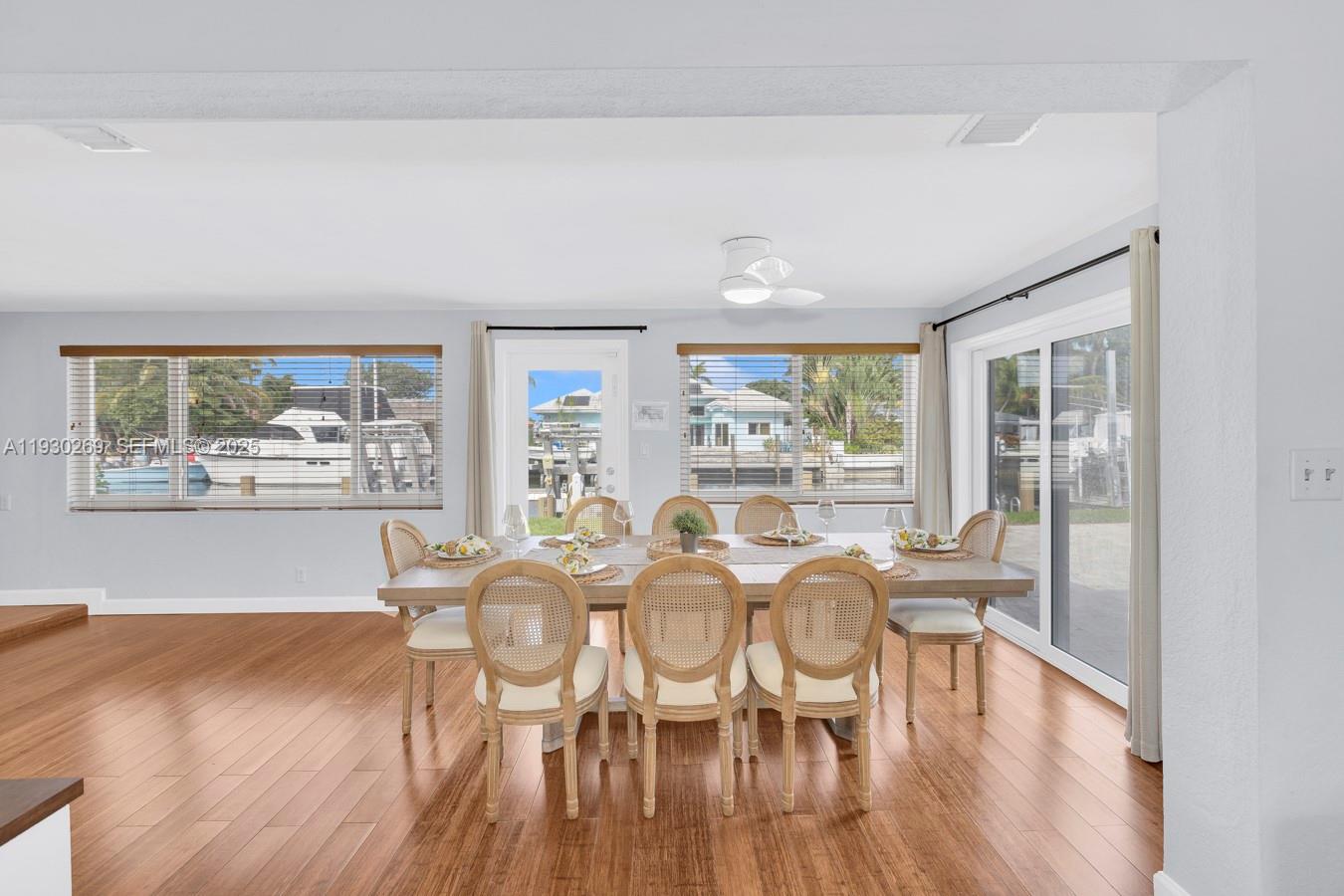 2875 Northeast 19th Street Pompano Beach, FL 33062 - Photo 72 of 79 a view of a dining room with furniture and wooden floor
