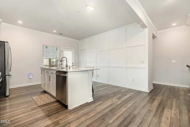 a kitchen with a sink and a refrigerator