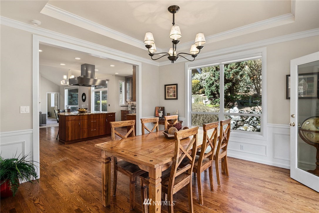 2009 Lyons Avenue Northeast Renton, WA 98059 - Photo 3 of 35 a view of a dining room with furniture a chandelier and wooden floor