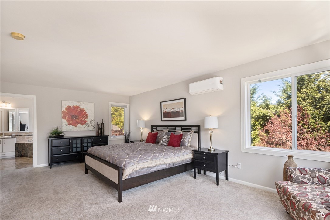 2009 Lyons Avenue Northeast Renton, WA 98059 - Photo 25 of 35 a bedroom with a large bed and a painting on the wall