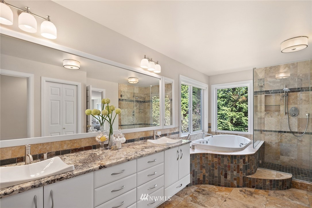 2009 Lyons Avenue Northeast Renton, WA 98059 - Photo 26 of 35 a bathroom with a double vanity sink a mirror and a bathtub