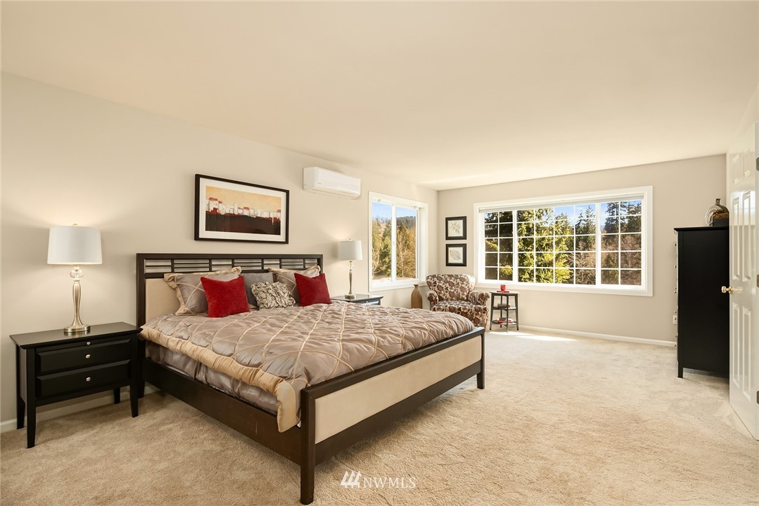 2009 Lyons Avenue Northeast Renton, WA 98059 - Photo 27 of 35 a bedroom with a bed lamp and a large window