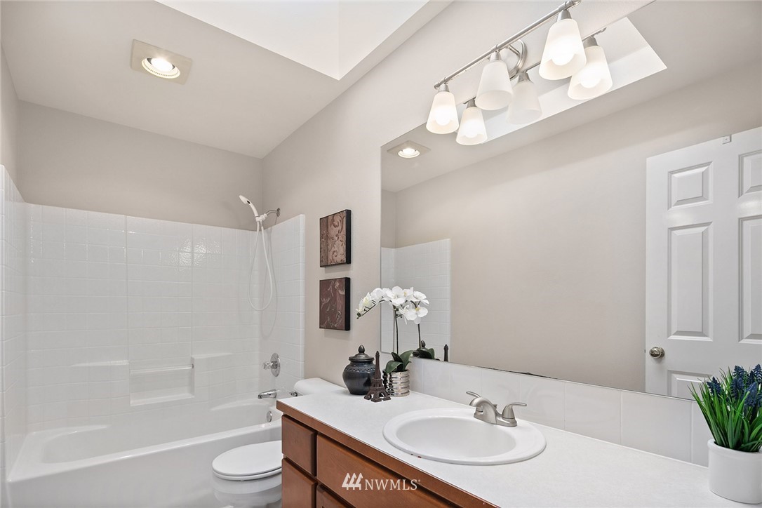 2009 Lyons Avenue Northeast Renton, WA 98059 - Photo 30 of 35 a bathroom with a granite countertop sink a toilet and shower