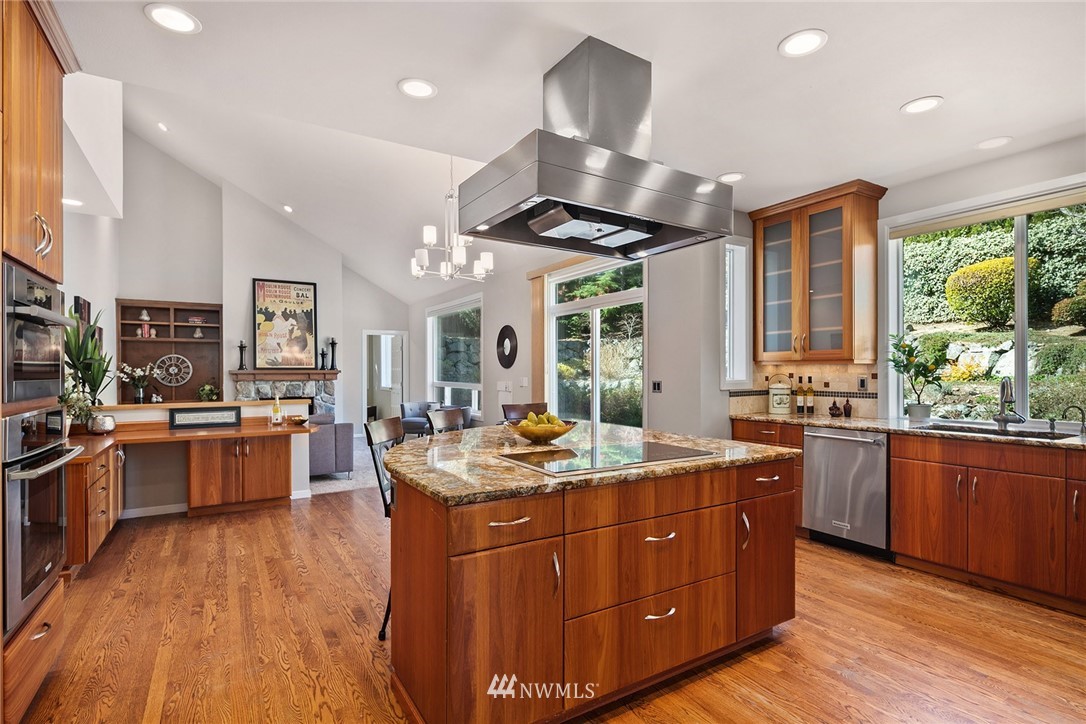 2009 Lyons Avenue Northeast Renton, WA 98059 - Photo 5 of 35 a kitchen with stainless steel appliances granite countertop wooden floors and sink