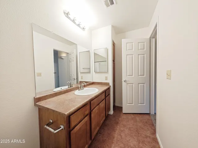 a bathroom with a sink a mirror and a vanity
