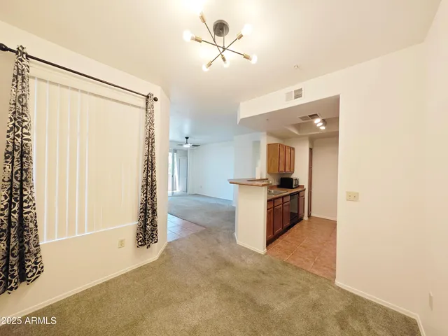 a kitchen with a refrigerator and a stove top oven