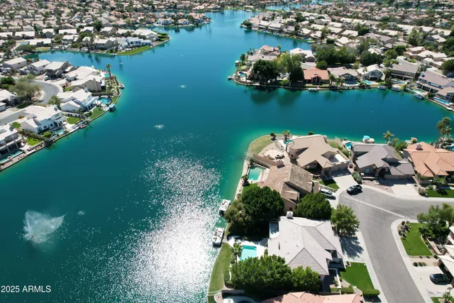 an aerial view of a house with a lake view