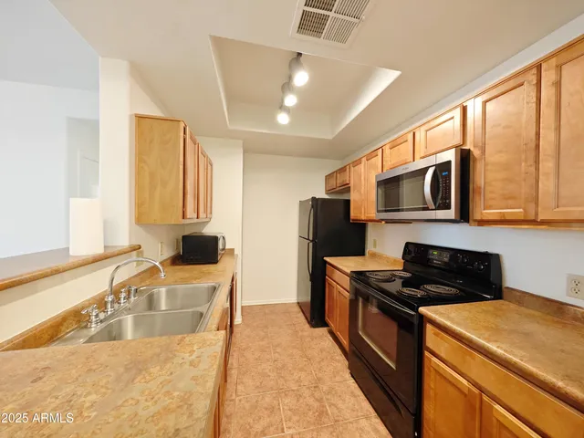 a kitchen that has a sink and a stove top oven