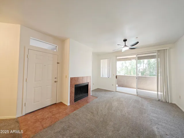 a view of empty room with window and fireplace