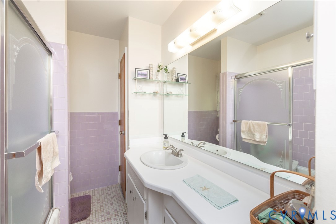 7035 Conifer Road Richmond, VA 23237 - Photo 16 of 38 Full bath with vanity, tile walls, bath / shower c