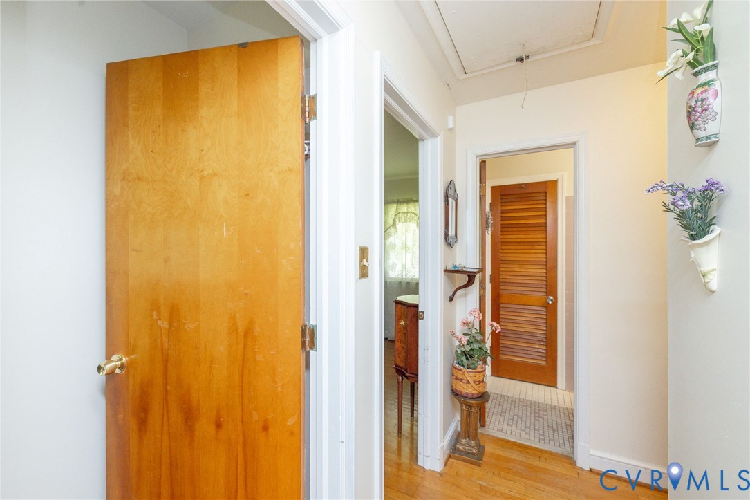 7035 Conifer Road Richmond, VA 23237 - Photo 17 of 38 Hallway featuring attic access and light wood-type