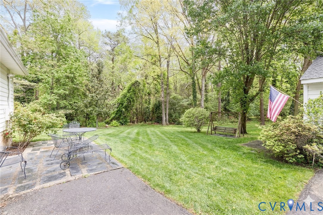 7035 Conifer Road Richmond, VA 23237 - Photo 37 of 38 View of grassy yard with a patio