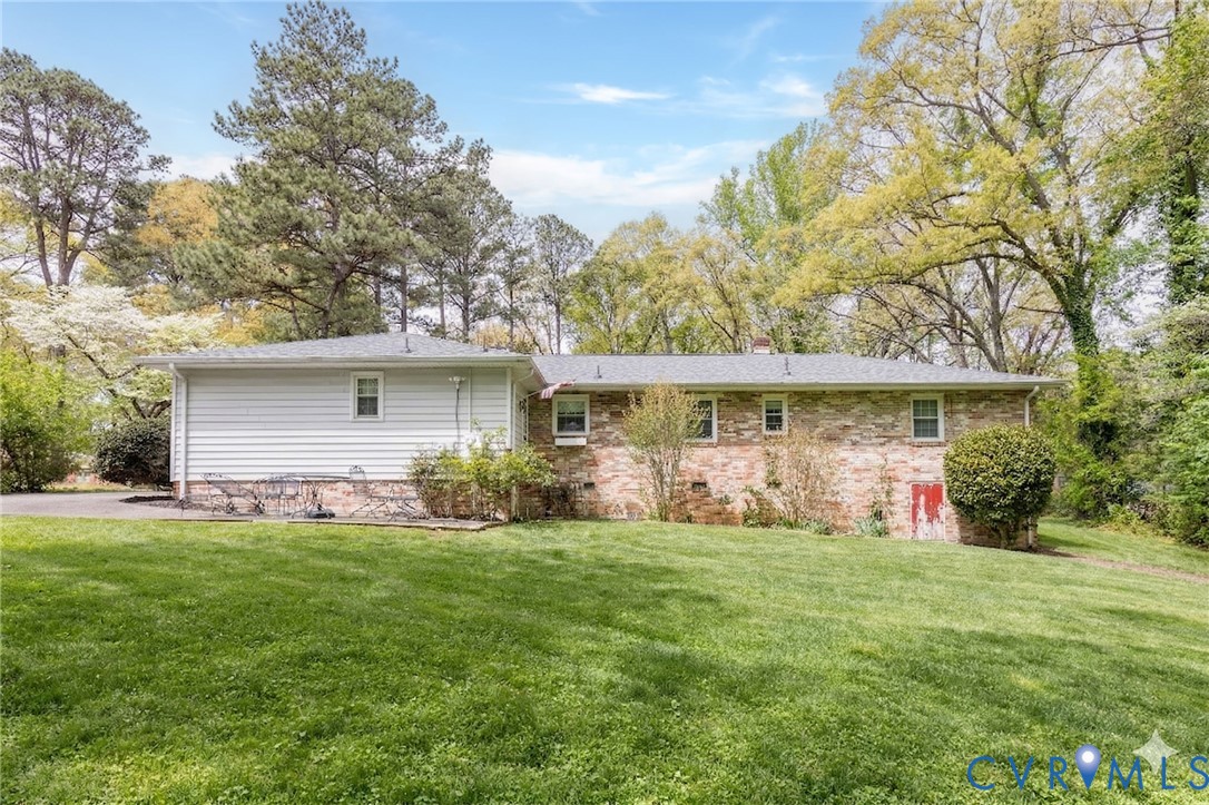 7035 Conifer Road Richmond, VA 23237 - Photo 38 of 38 Rear view of property with a yard, a chimney, and